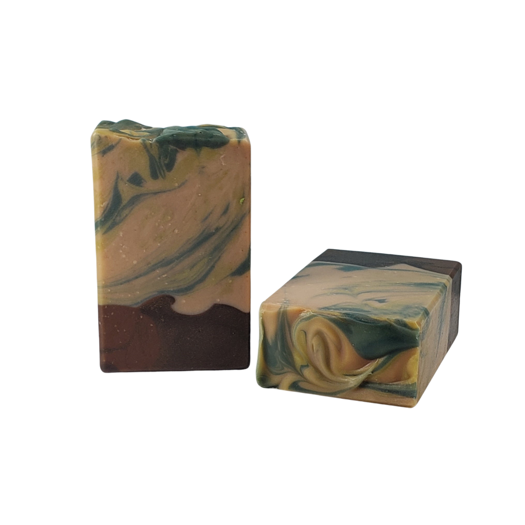 NW Soap bars of Woodlands unwrapped with brown base and upper portion of green swirls.