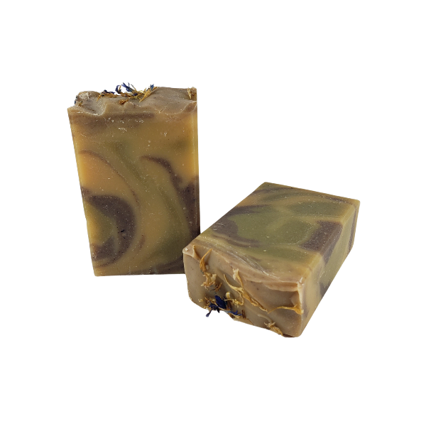 Two unwrapped bars of The Hippie goat milk soap bars.