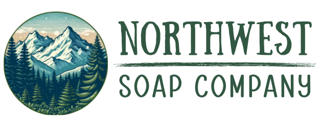 Logo of Northwest Soap Company with illustration of mountains and evergreens.  Name in dark green with drawn line between Northwest and Soap Company.