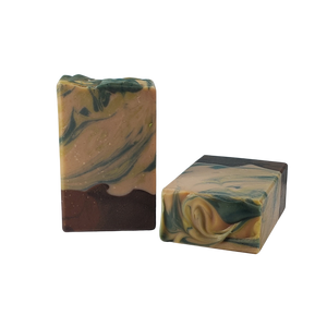 NW Soap bars of Woodlands unwrapped with brown base and upper portion of green swirls.