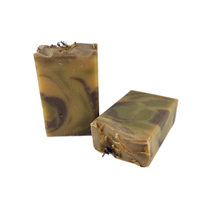 Two unwrapped bars of The Hippie goat milk soap bars.