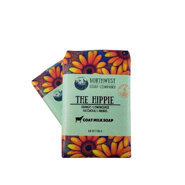 Two wrapped bars of The Hippie soap in custom printed paper with boldly colored sunflowers.