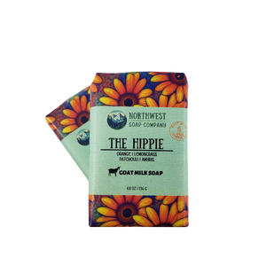 Two wrapped bars of The Hippie soap in custom printed paper with boldly colored sunflowers.