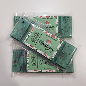 3 Christmas Cabin wax melts packaged in their recylable 5 PP wrappers.  Shaped like a candy bar in dark green with eco glitter.