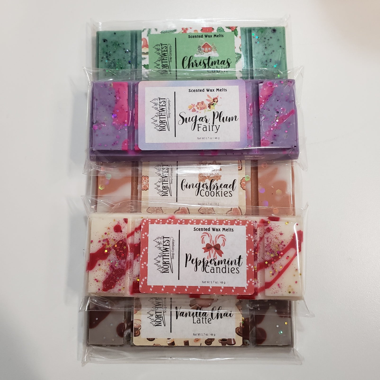 5 of our Holiday Collection wax melts.  Sugar Plum Fairy, Gingerbread Cookies, Peppermint Candies, Christmas Cabin, and Vanilla Chai Latte.