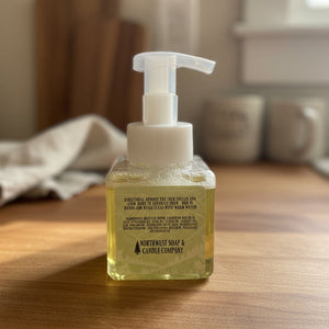 Bottle of soap with pump on a wooden surface, blurred background