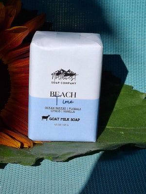 Bar of soap pictured with sunflower on blue background