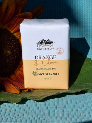 Bar of soap pictured with a sunflower on blue background