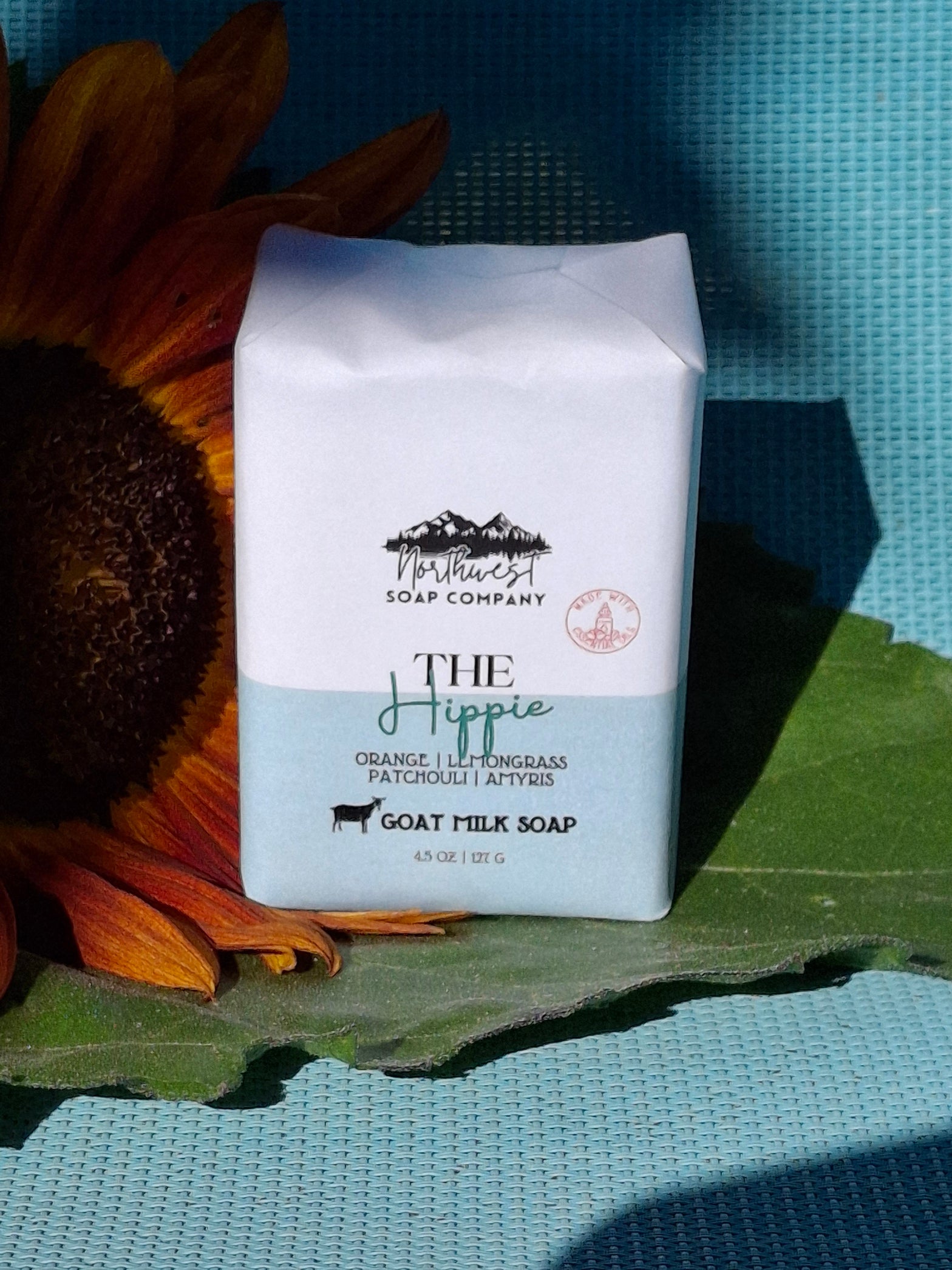 Two unwrapped bars of The Hippie goat milk soap bars.