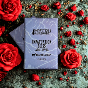 two bars of infatuation bliss soap on background with red roses 