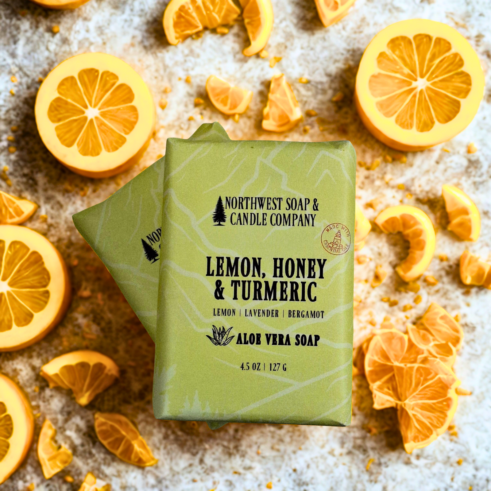 Two unwrapped bars of Lemon, Honey, and Turmeric body bar soap.