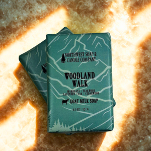 Two bars of soap from Northwest Soap & Candle Company on a textured surface