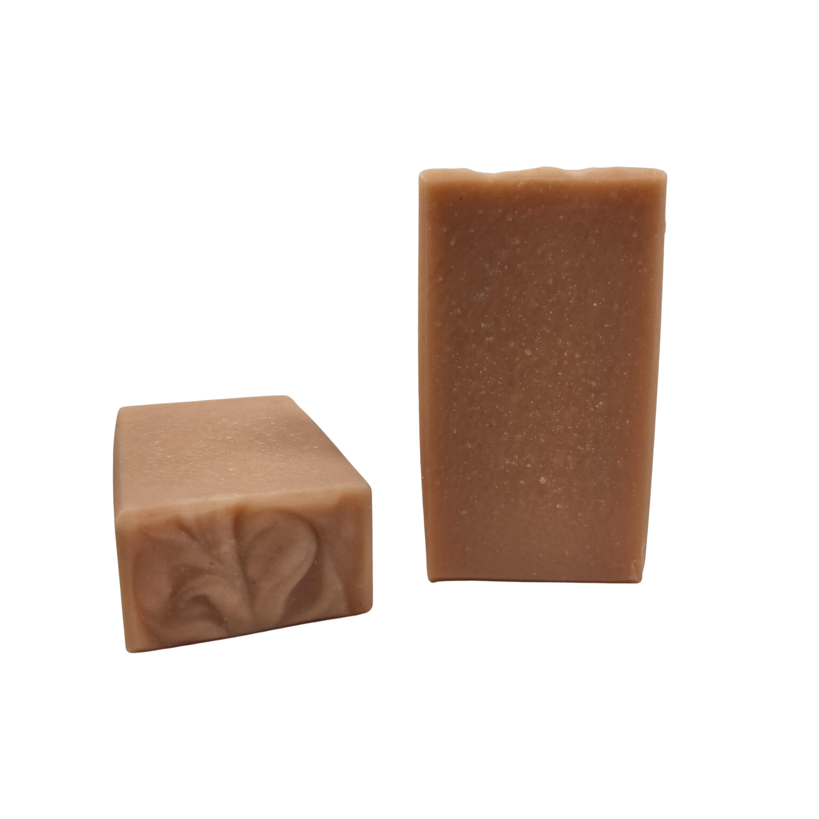 Two bars of Coconut Rose soap that are pale pink in color.