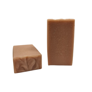 Two bars of Coconut Rose soap that are pale pink in color.
