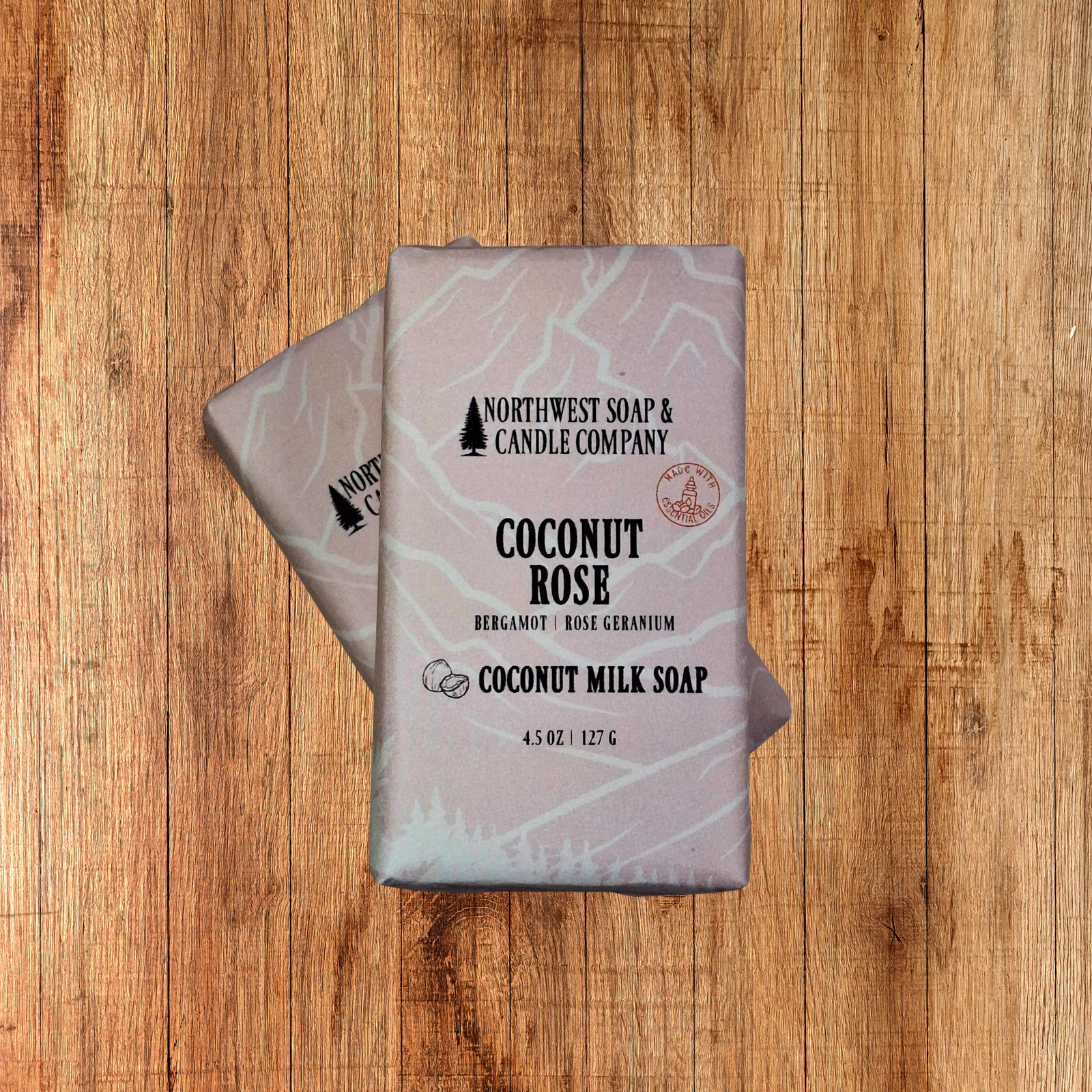 Two bars of Coconut Rose soap that are pale pink in color.