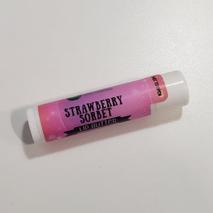 One tube of our Strawberry Sorbet lip butter with it's white lip balm tube and pink label.