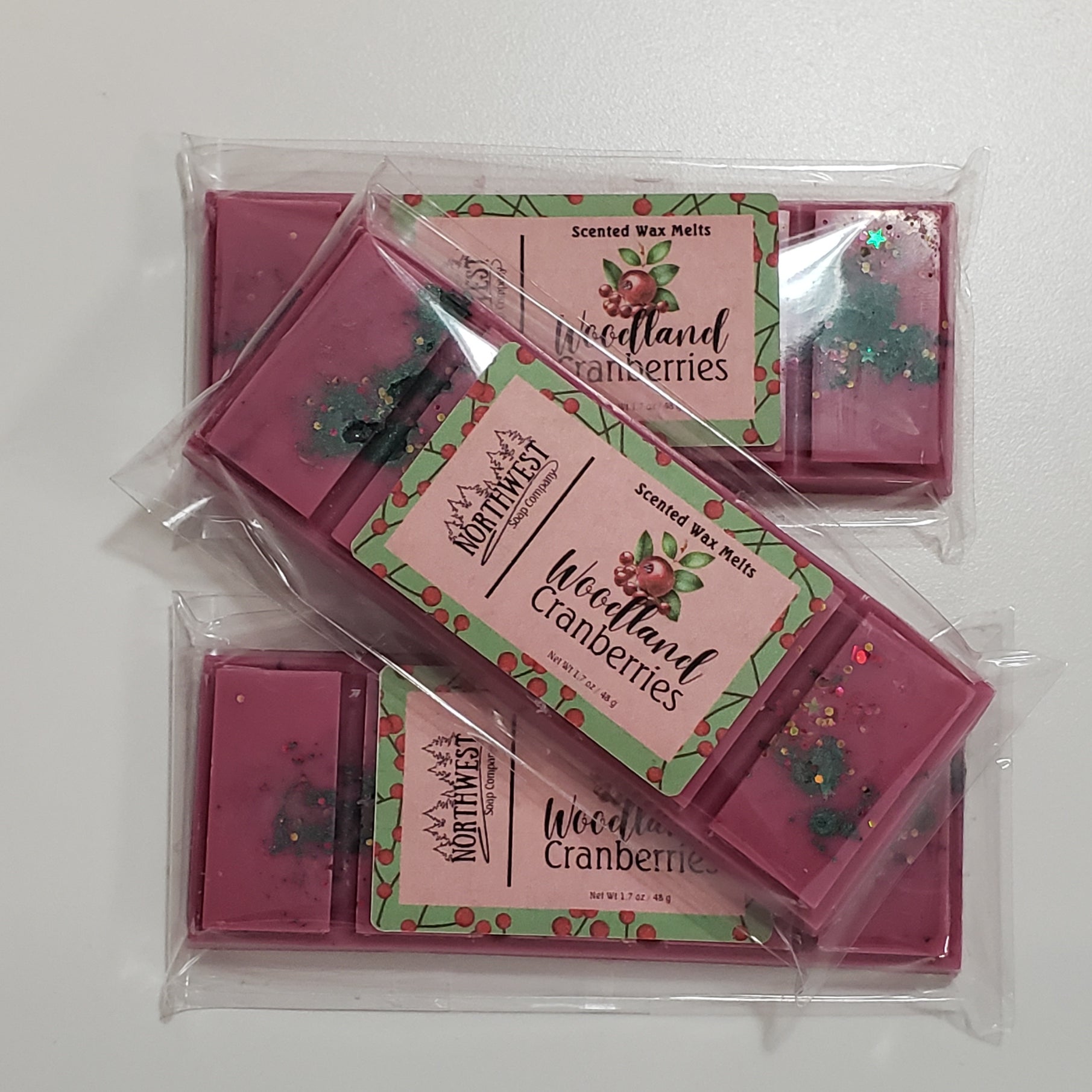 3 Woodland Cranberries Wax melts in their recyclable 5 PP wrappers.  Dark burgandy with green mica spots and eco glitter.